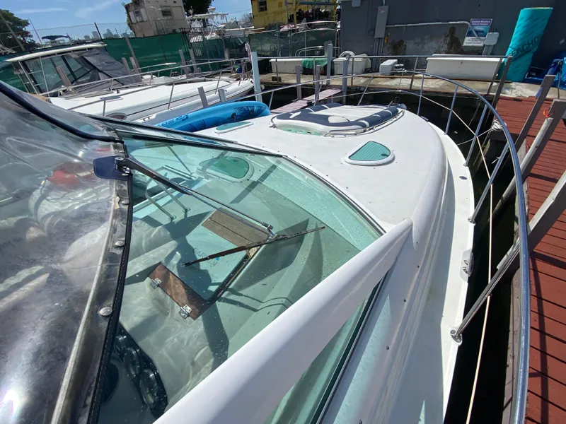 Slide: The Image of 2006 Doral 365 boat docked, featuring sleek design and spacious deck area. - 23