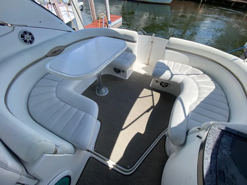 Slide: The Image of Luxurious seating area on a 2006 Doral 365 boat with white upholstery and table. - 26