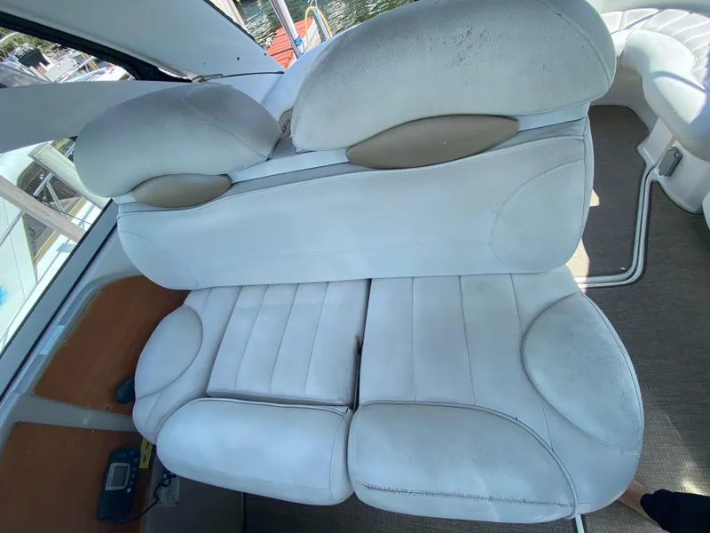 Slide: The Image of White leather seating on a 2006 Doral 365 boat interior. - 28