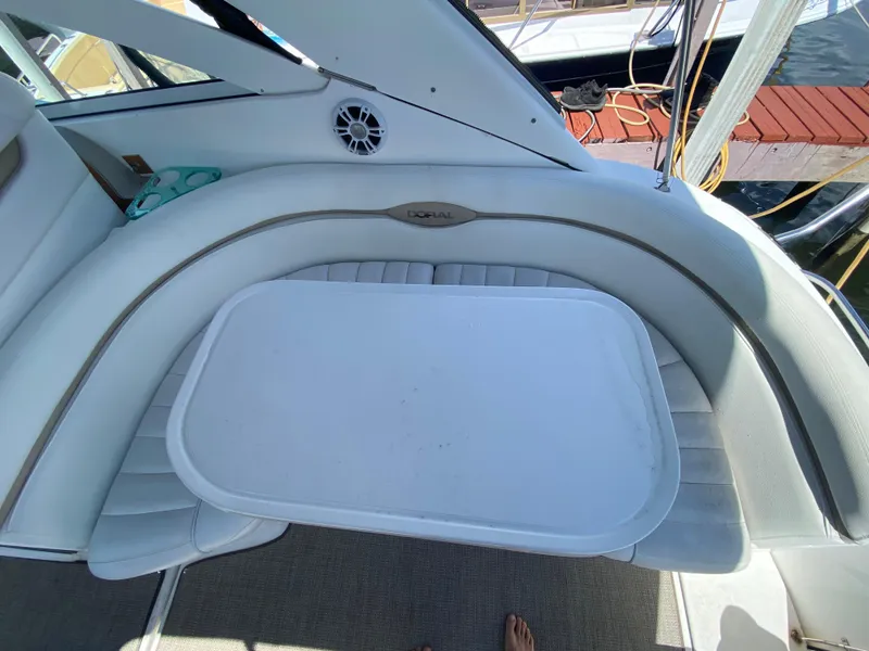 Slide: The Image of Interior of a 2006 Doral 365 boat with white seating and table. - 29