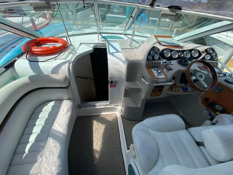 Slide: The Image of Interior of a 2006 Doral 365 boat with steering wheel and seating area. - 30