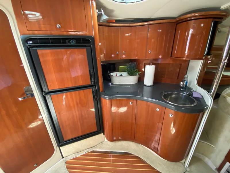 Slide: The Image of Interior of 2006 Doral 365 yacht kitchen with wood cabinetry and compact design. - 35