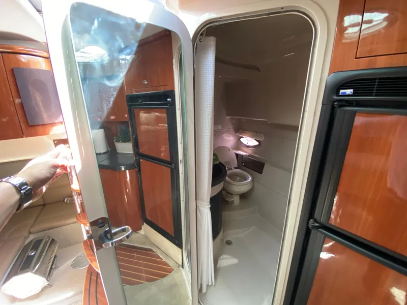 Slide: The Image of Interior of a 2006 Doral 365 boat showing bathroom and kitchenette area. - 37