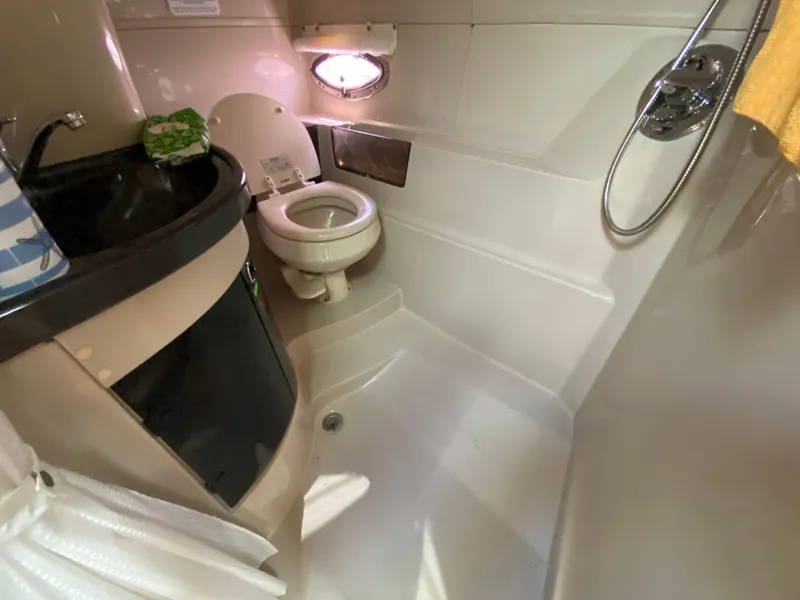 Slide: The Image of Compact bathroom in 2006 Doral 365 boat with toilet, sink, and shower. - 39