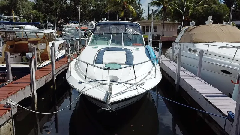 Slide: The Image of 2006 Doral 365 boat docked at marina, surrounded by other vessels and palm trees. - 4
