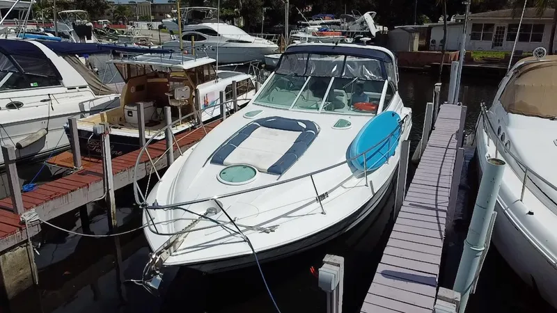 Slide: The Image of 2006 Doral 365 boat docked at a marina, surrounded by other vessels. - 5