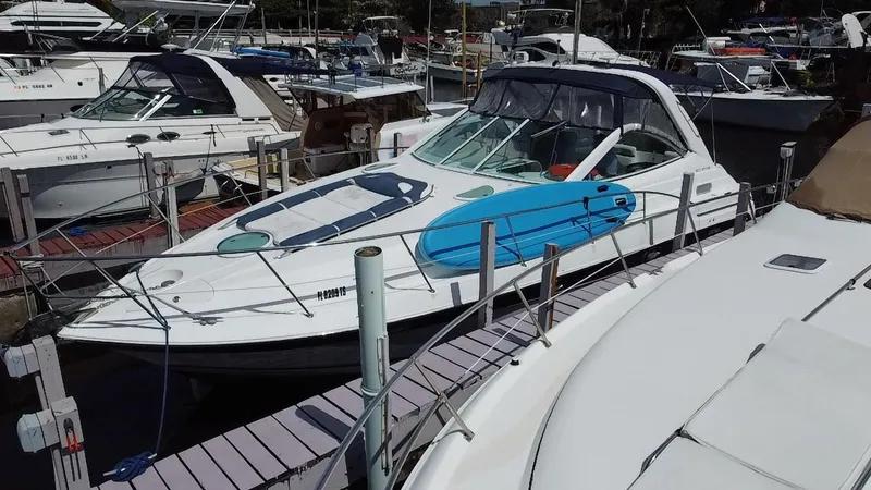 Slide: The Image of 2006 Doral 365 boat docked at marina, surrounded by other vessels. - 6
