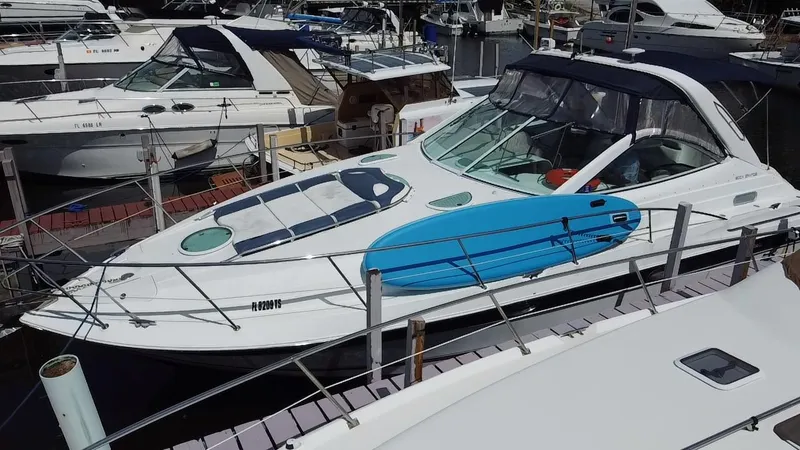 Slide: The Image of 2006 Doral 365 boat docked with a blue paddleboard on deck. - 7