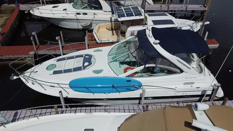 Slide: The Image of 2006 Doral 365 boat docked with blue paddleboard on deck, surrounded by other boats. - 9