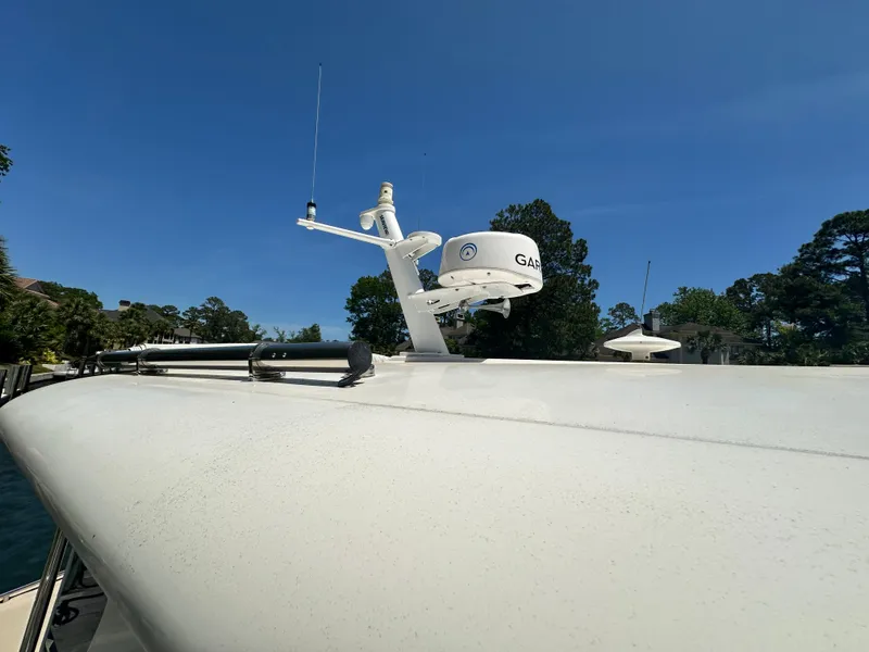 Slide: The Image of 2022 Back Cove 372 boat with radar equipment against clear blue sky. - 13