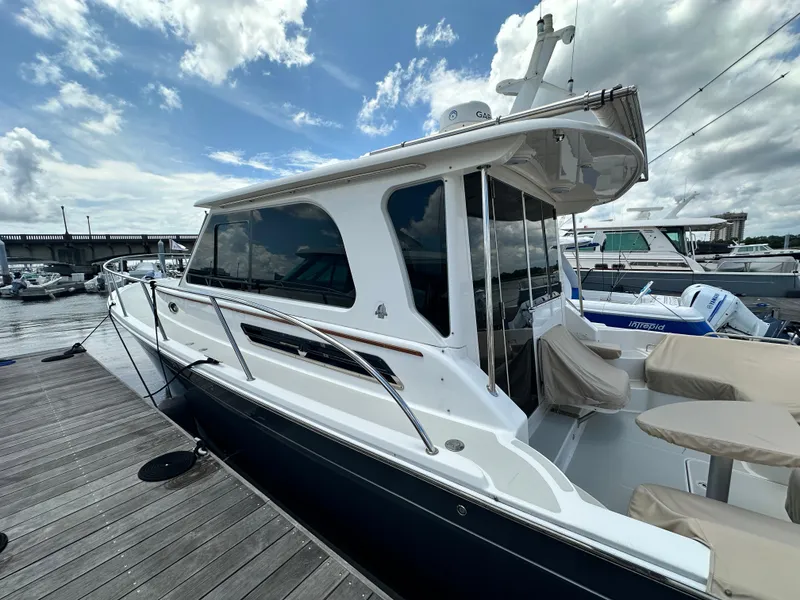 Slide: The Image of 2022 Back Cove 372 yacht docked at marina under cloudy sky. - 16