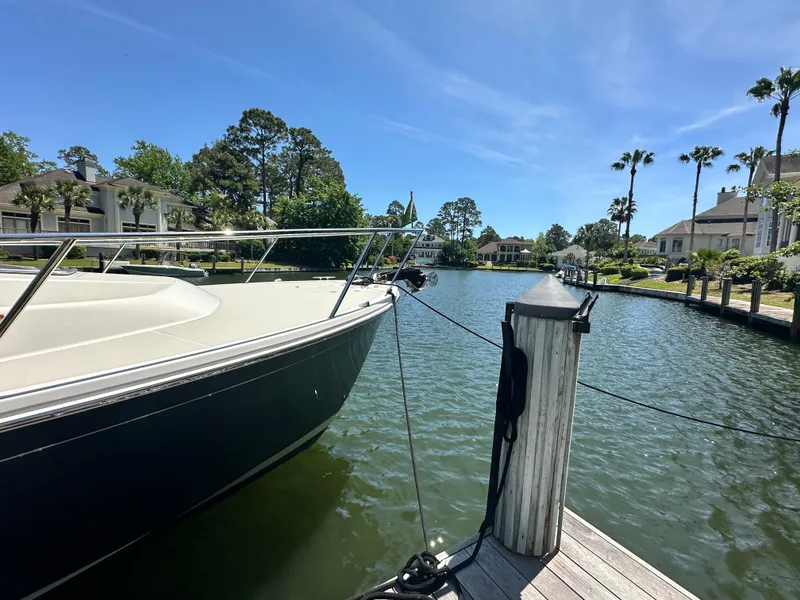 Slide: The Image of 2022 Back Cove 372 yacht docked in a scenic waterfront neighborhood. - 19