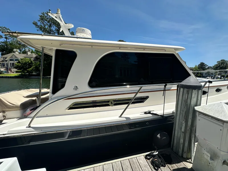 Slide: The Image of 2022 Back Cove 372 yacht docked at marina under clear blue sky. - 22