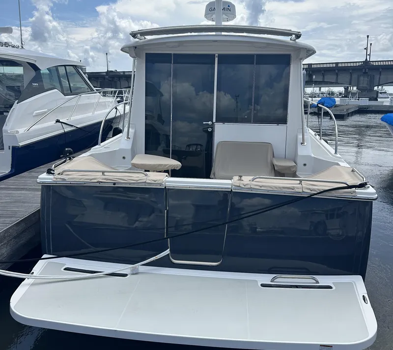 Slide: The Image of 2022 Back Cove 372 yacht docked at marina, rear view with seating and swim platform. - 24