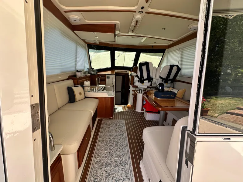 Slide: The Image of Interior of 2022 Back Cove 372 yacht, featuring elegant seating and modern amenities. - 25