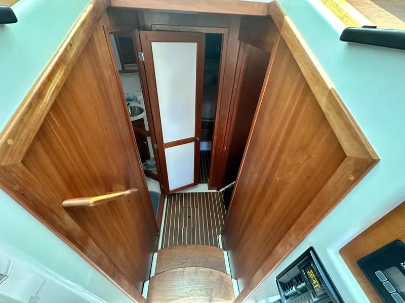 Slide: The Image of Interior view of 2022 Back Cove 372 boat, featuring wooden finishes and a compact layout. - 33
