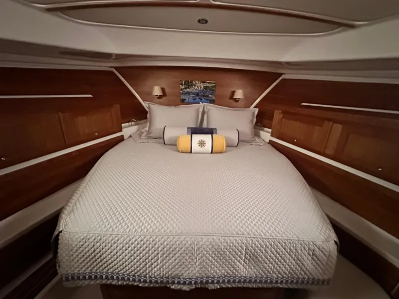 Slide: The Image of Luxurious cabin interior of 2022 Back Cove 372 yacht with elegant bedding and wood paneling. - 36