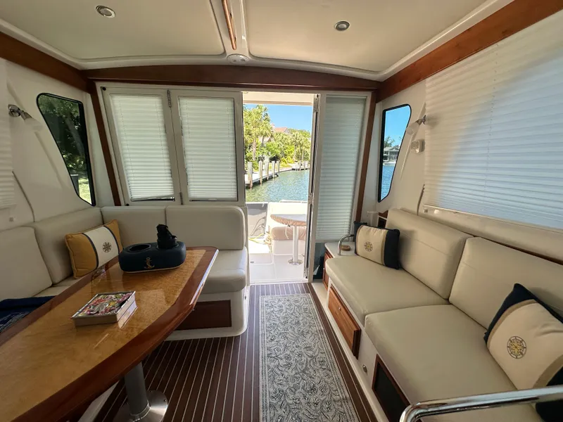 Slide: The Image of Luxurious interior of 2022 Back Cove 372 yacht with elegant seating and scenic water view. - 38
