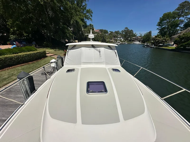 Slide: The Image of 2022 Back Cove 372 yacht docked by a scenic waterfront. - 8