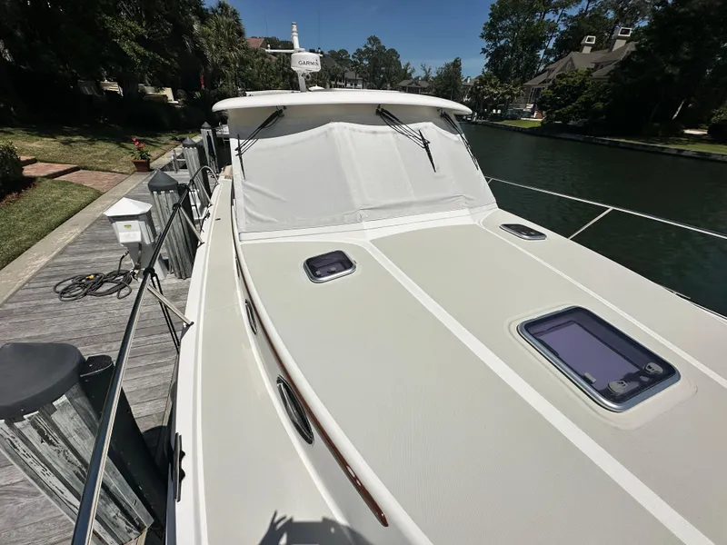 Slide: The Image of 2022 Back Cove 372 boat docked, featuring sleek design and modern equipment. - 9