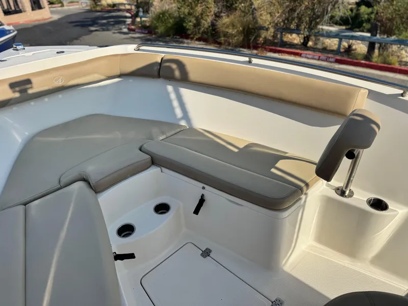 Slide: The Image of 2021 Sailfish 242 CC boat interior with beige seating and cup holders. - 10