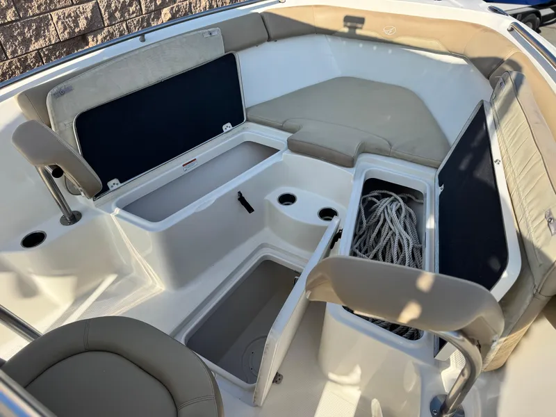 Slide: The Image of 2021 Sailfish 242 CC boat interior with storage compartments and seating. - 13