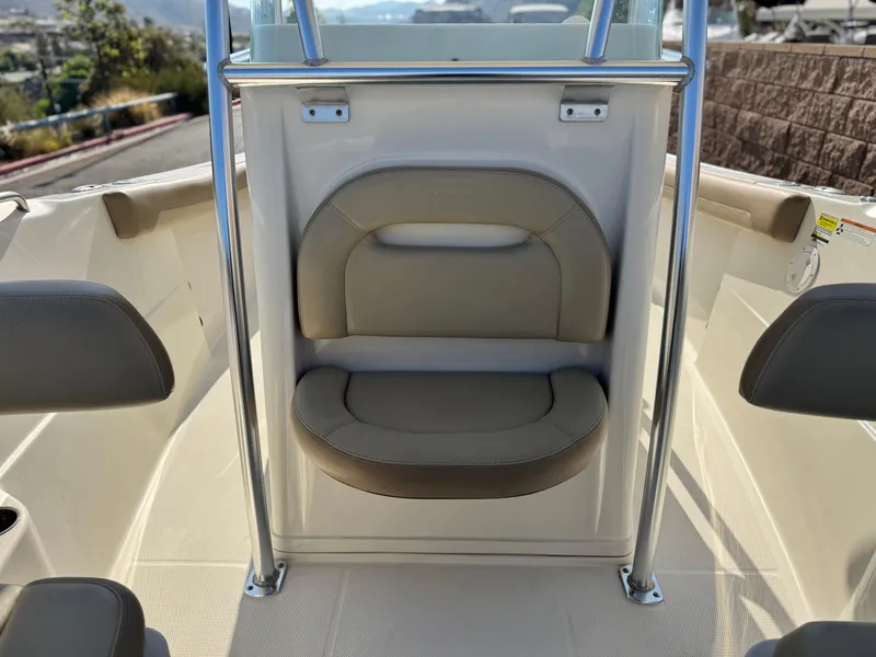 Slide: The Image of 2021 Sailfish 242 CC boat interior with cushioned seating and stainless steel railings. - 14