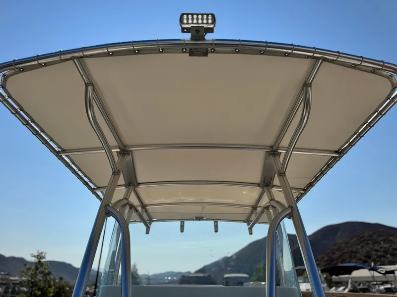 Slide: The Image of T-top canopy of 2021 Sailfish 242 CC boat against clear blue sky. - 15