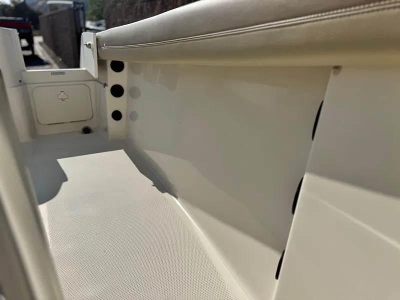 Slide: The Image of Interior view of a 2021 Sailfish 242 CC boat, featuring sleek seating and storage compartments. - 17