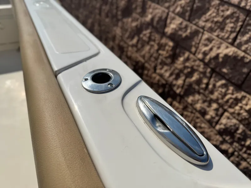 Slide: The Image of 2021 Sailfish 242 CC boat detail showing rod holder and cleat on deck. - 18