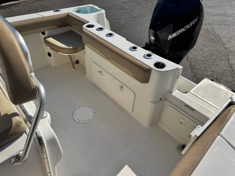 Slide: The Image of 2021 Sailfish 242 CC boat interior with seating, storage, and Mercury engine. - 20