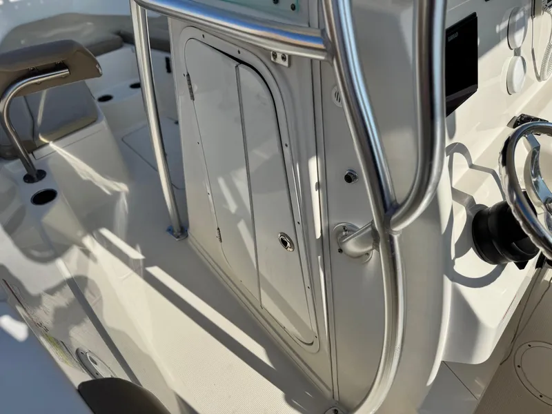 Slide: The Image of 2021 Sailfish 242 CC boat interior with steering wheel and storage compartment. - 27