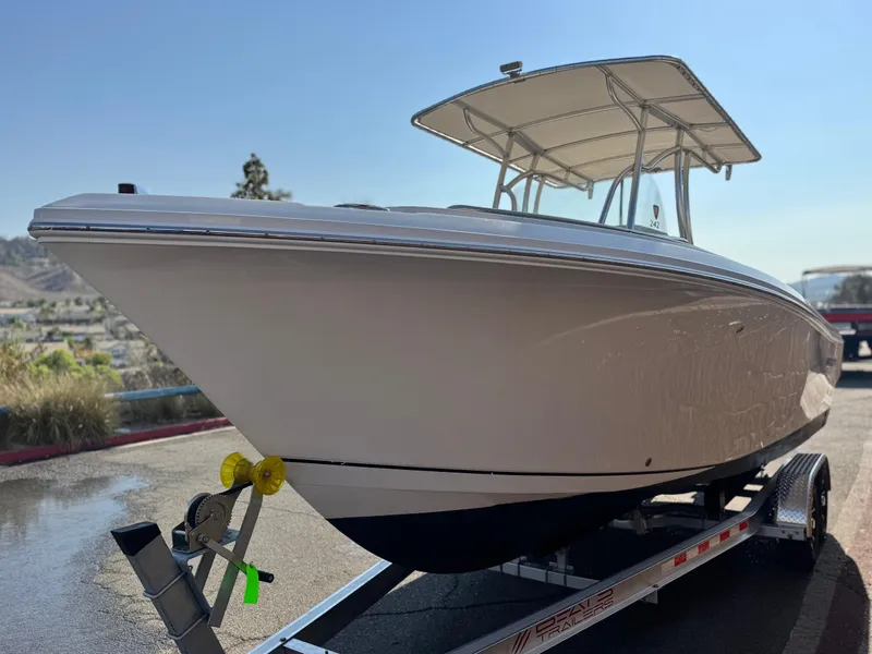 Slide: The Image of 2021 Sailfish 242 CC boat on trailer, parked outdoors under clear sky. - 3