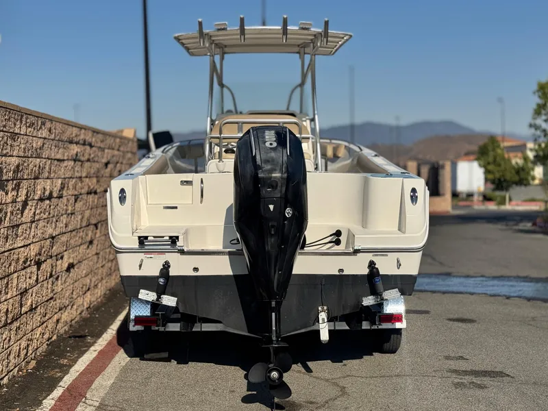 Slide: The Image of 2021 Sailfish 242 CC boat with outboard motor, parked on a street. - 4