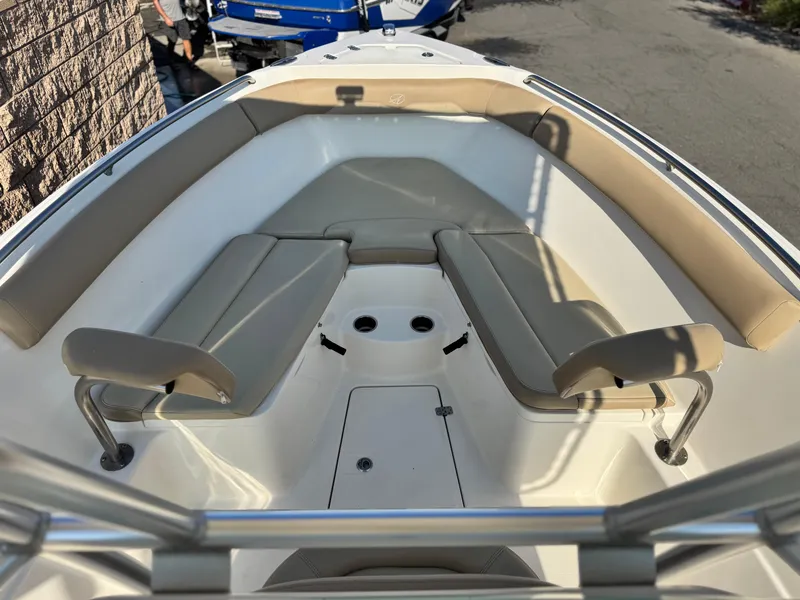 Slide: The Image of 2021 Sailfish 242 CC boat interior with beige seating and stainless steel railings. - 8