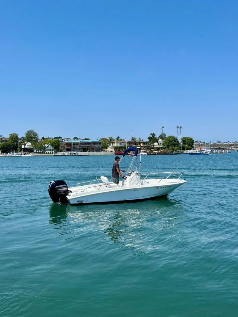 Slide: The Image of 2016 Boston Whaler 180 Dauntless boat cruising on a sunny day. - 13