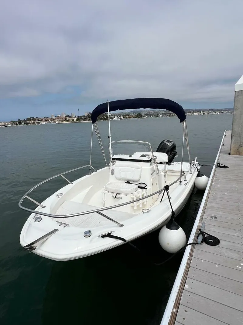 Slide: The Image of 2016 Boston Whaler 180 Dauntless boat docked by the pier on a calm day. - 7