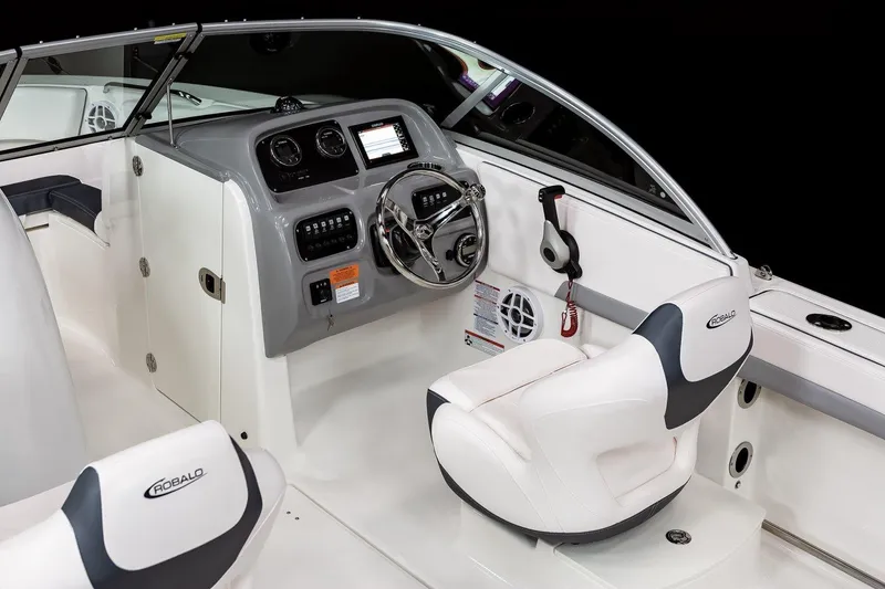 Slide: The Image of 2024 Robalo R207 Dual Console boat interior with steering wheel and seating. - 13