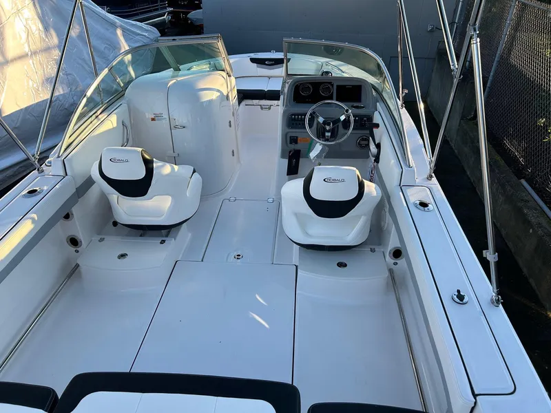 Slide: The Image of 2026 Robalo R207 Dual Console boat interior with steering wheel and seating. - 19