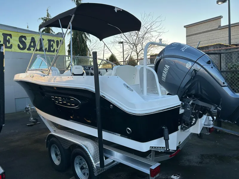 Slide: The Image of 2026 Robalo R207 Dual Console boat with Yamaha engine on trailer. - 2