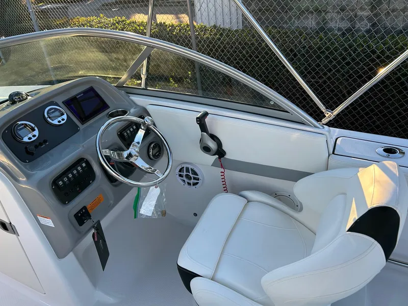 Slide: The Image of 2026 Robalo R207 Dual Console boat interior with steering wheel and dashboard controls. - 20
