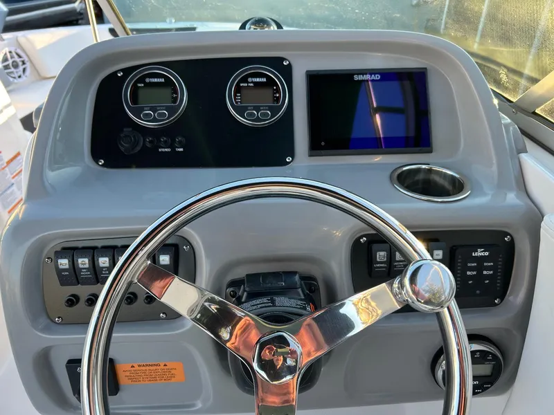 Slide: The Image of 2026 Robalo R207 Dual Console dashboard with steering wheel, gauges, and Simrad display. - 22