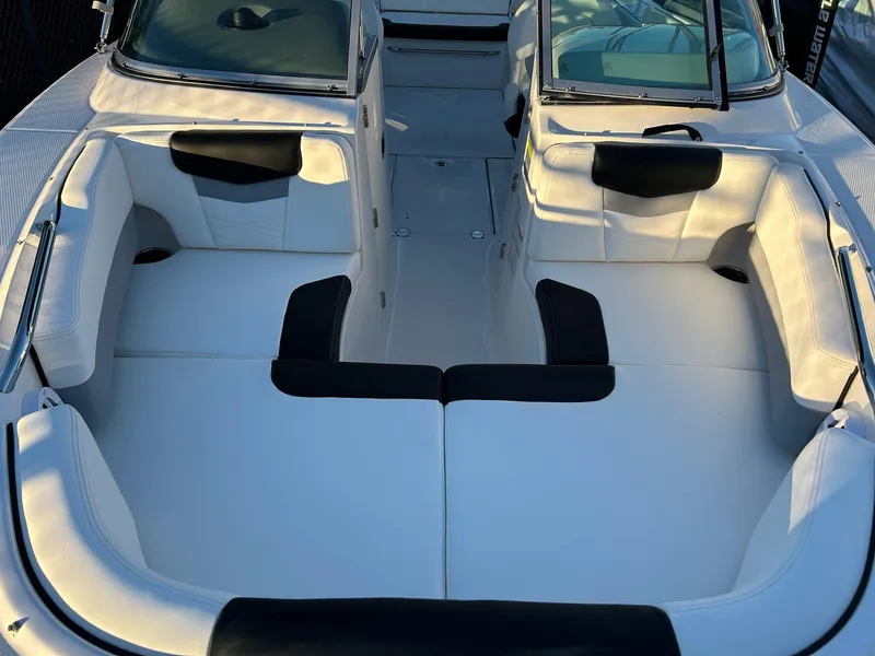 Slide: The Image of 2026 Robalo R207 Dual Console boat interior with white and black seating. - 24