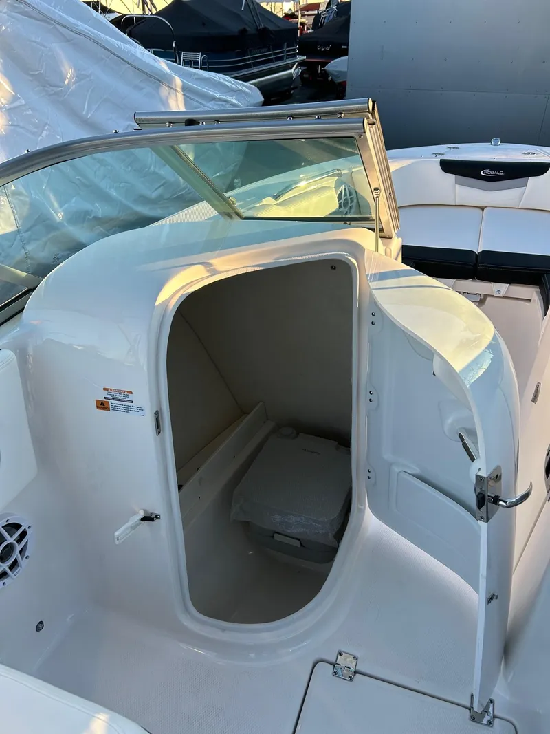 Slide: The Image of 2026 Robalo R207 Dual Console boat interior with open storage compartment. - 27