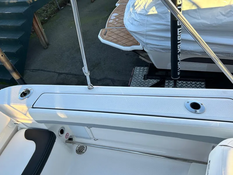 Slide: The Image of 2026 Robalo R207 Dual Console boat interior with rod holders and seating area. - 30