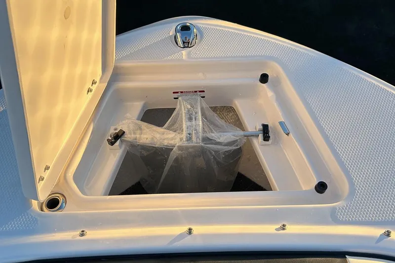 Slide: The Image of Open storage compartment on 2026 Robalo R207 Dual Console boat. - 34