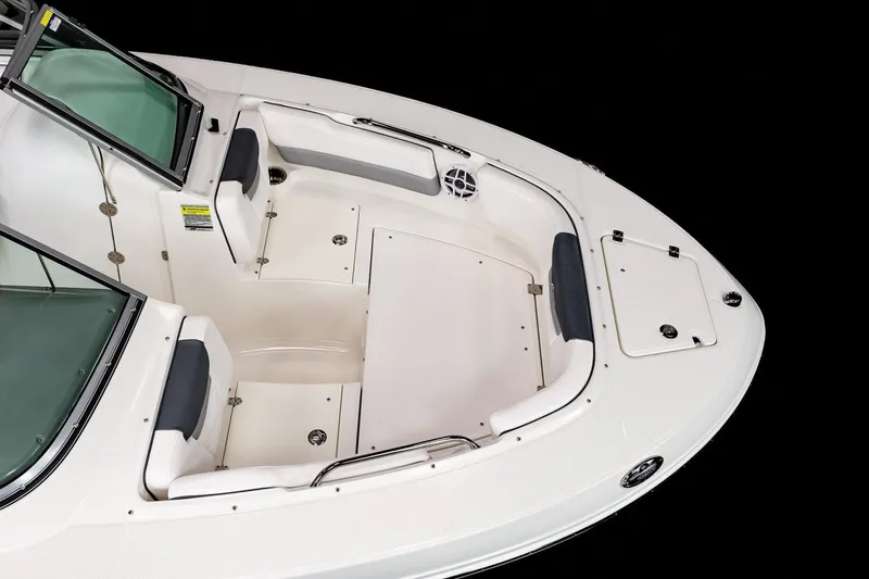 Slide: The Image of 2024 Robalo R207 Dual Console boat interior, white seating and storage compartments. - 9
