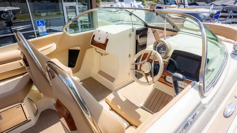 Slide: The Image of 2025 Chris-Craft Launch 28 GT interior with luxurious beige seating and modern dashboard. - 10