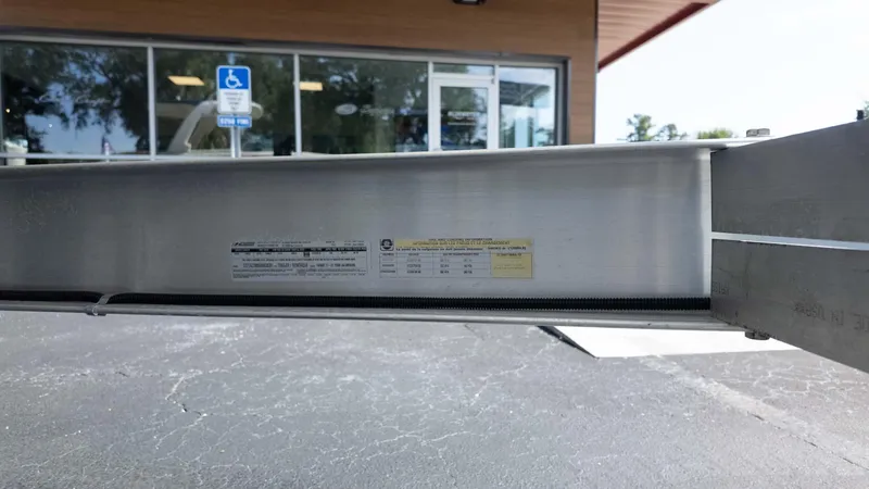 Slide: The Image of Close-up of a Chris-Craft Launch 28 GT 2025 boat trailer detail, with a building in the background. - 15