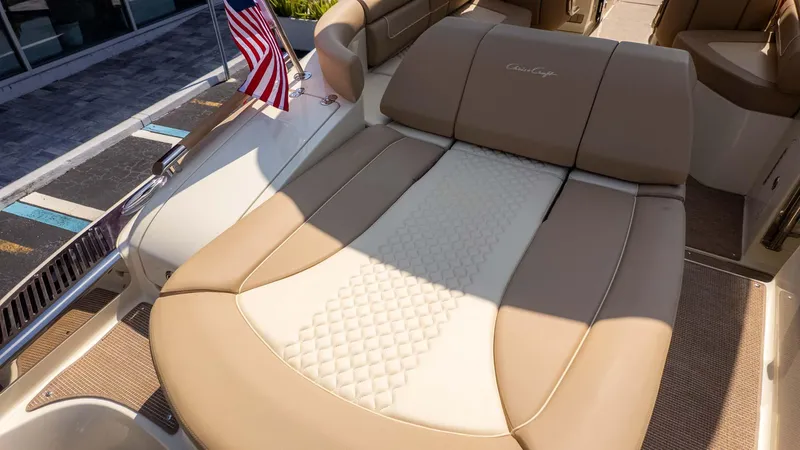 Slide: The Image of 2025 Chris-Craft Launch 28 GT boat with luxurious tan and white seating. - 19